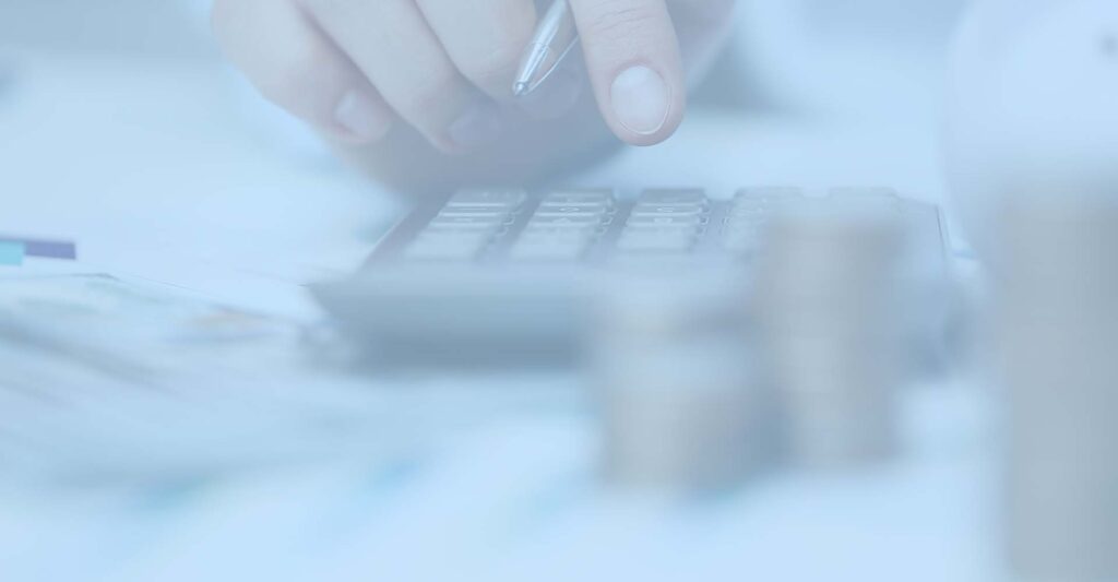 Person using calculator while counting finances